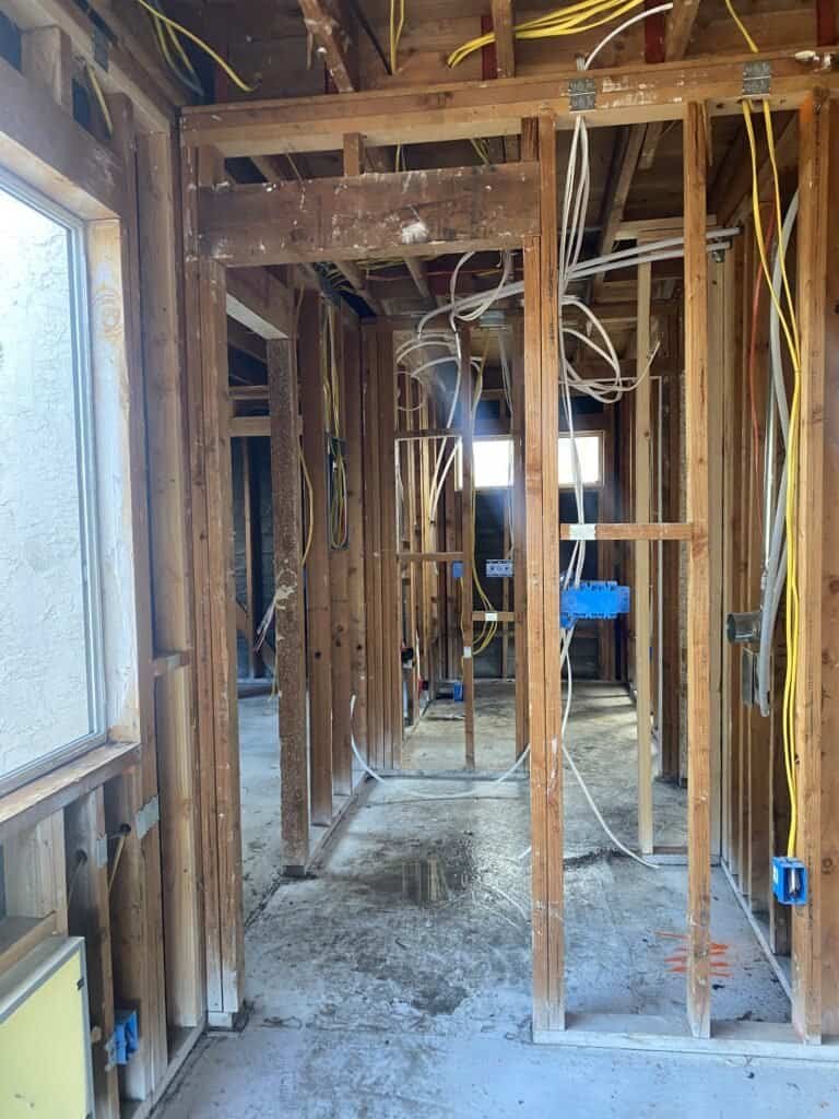 High-quality plumbing rough-in process for new home construction with exposed pipes and wiring.